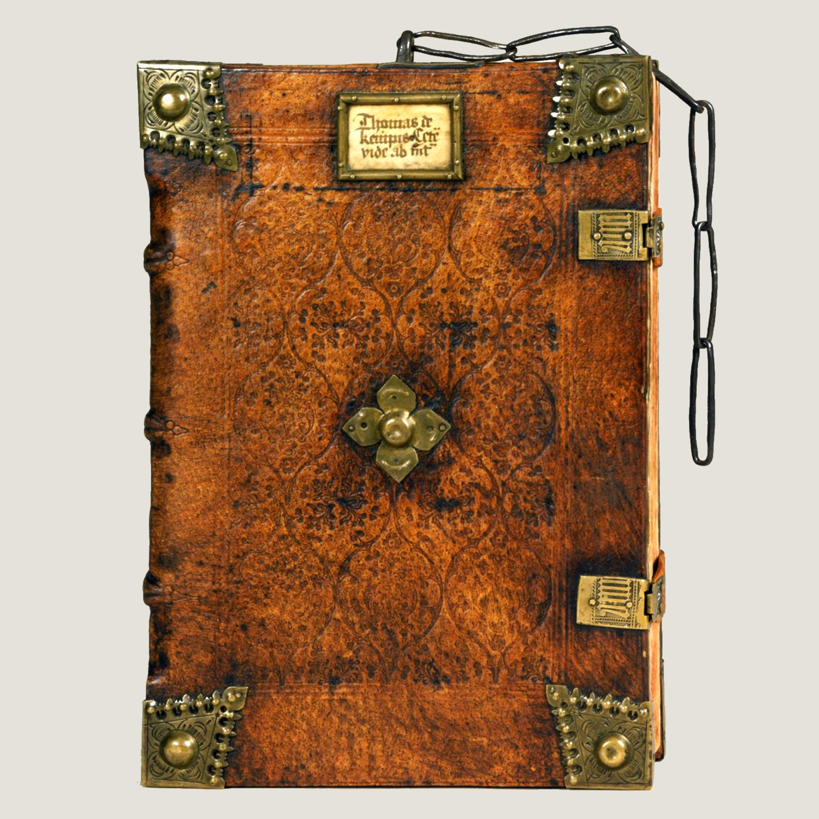 a brown leather binding with brass bosses on the four corners and a chain at top